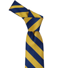 Load image into Gallery viewer, Knot on a blue velvet and gold striped necktie