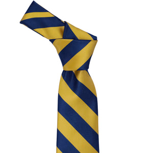 Knot on a blue velvet and gold striped necktie
