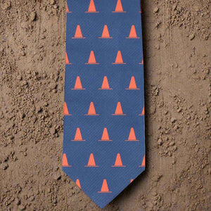 Construction cone themed necktie on dirt