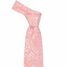 Load image into Gallery viewer, Tied knot on a coral paisley necktie