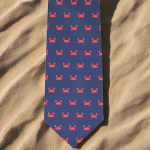 Crab themed necktie on a sandy beach background