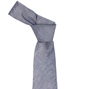 The knot on a dark blue linen tie