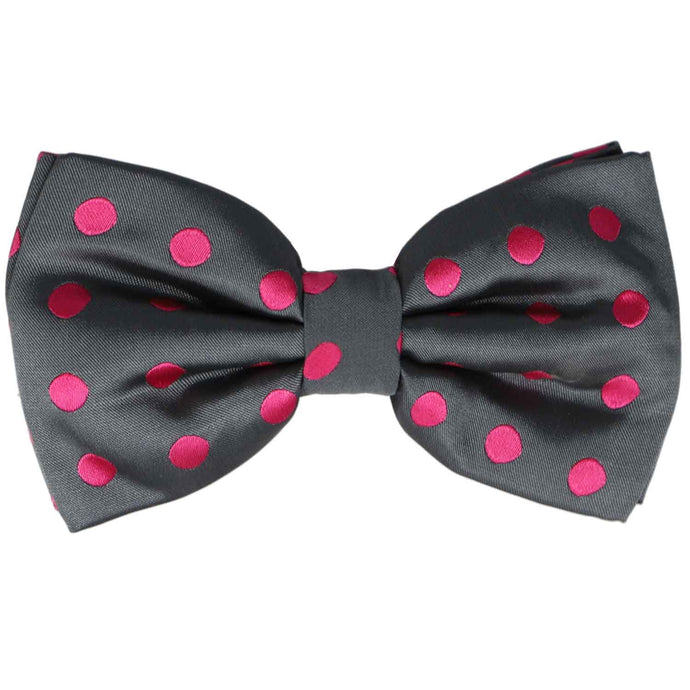 A gray bow tie with fuchsia polka dots