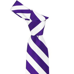 Knot on a dark purple and white striped tie