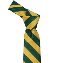 Load image into Gallery viewer, Knot on a hunter green and gold striped tie