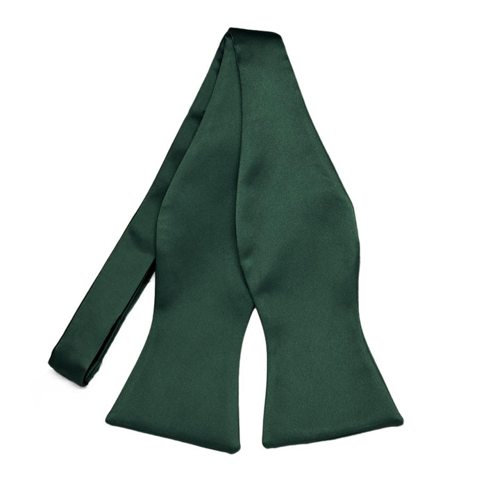 An untied, hunter green self-tie bow tie