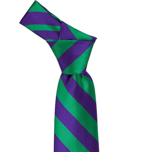 Knot on a kelly green and dark purple striped tie knot