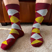 Load image into Gallery viewer, A man wearing maroon and gold argyle socks