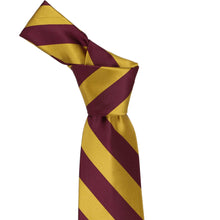 Load image into Gallery viewer, Knot on a maroon and gold striped tie