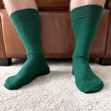 Load image into Gallery viewer, Closeup of a man wearing hunter green solid socks