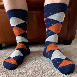 Man wearing a pair of navy blue and orange argyle socks