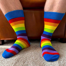 Load image into Gallery viewer, A man wearing rainbow striped socks