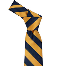 Load image into Gallery viewer, Knot on a navy blue and gold bar striped tie