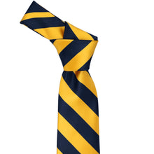 Load image into Gallery viewer, Knot on a navy blue and golden yellow striped tie
