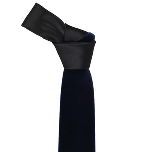 Knot on a navy blue velvet necktie