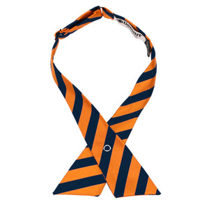 An orange and navy blue striped crossover tie with a metal snap