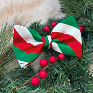 Green, red and white striped Christmas bow tie on pine garland