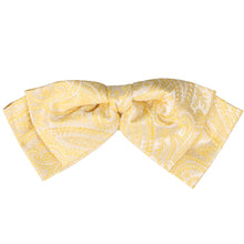 Load image into Gallery viewer, Front view of a soft yellow paisley floppy bow tie