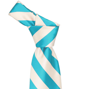 Knot on a turquoise and cream striped tie