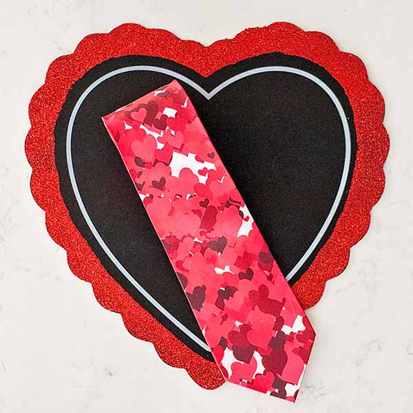 Necktie with red hearts displayed on a red heart