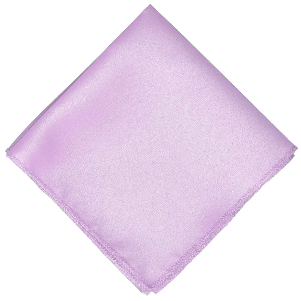 A light purple pocket square, folded into a diamond shape
