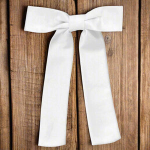 White kentucky colonel tie on a distressed wood background