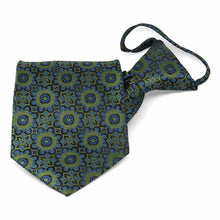 Load image into Gallery viewer, Folded front view of a green and blue floral pattern zipper style tie