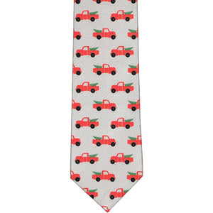 The front of a boys' gray tie with Christmas red pickup trucks