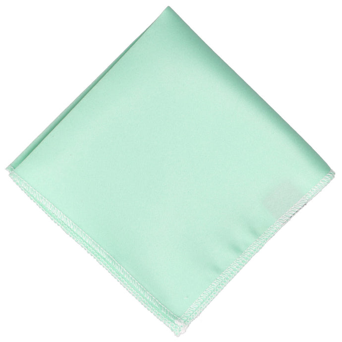 Solid light seafoam pocket square folded into a diamond