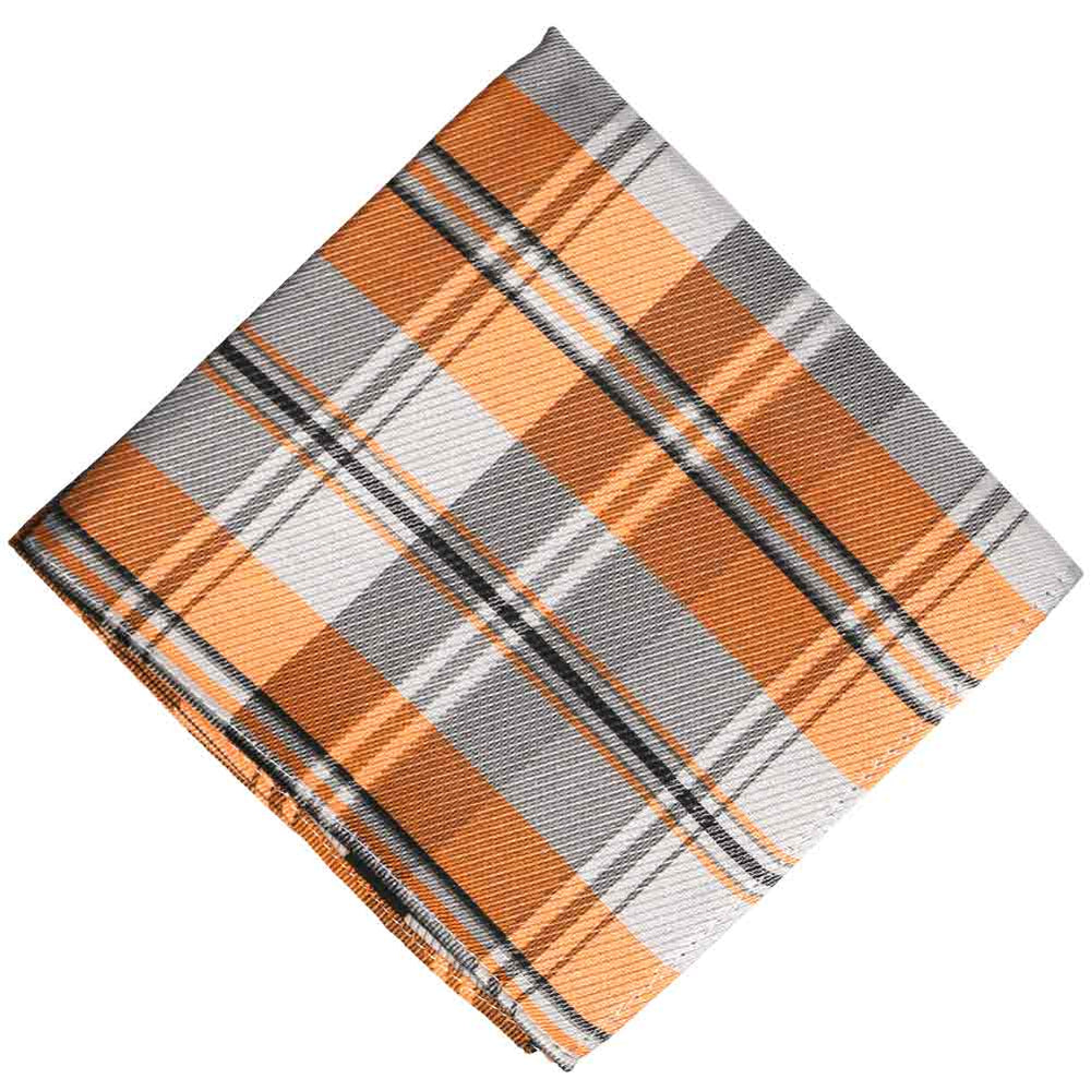 A folded orange white and gray plaid pocket square