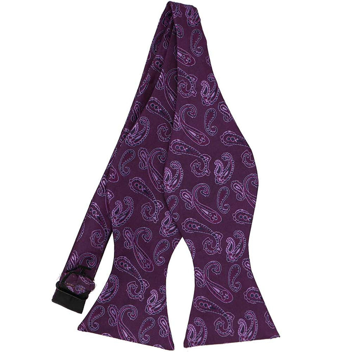 Eggplant purple paisley pattern on an untied self-tie bow tie